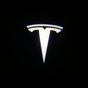Tesla door light logo projected on a black background