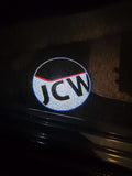 Red and white Mini John Cooper Works logo projected onto the ground by the car’s door puddle light
